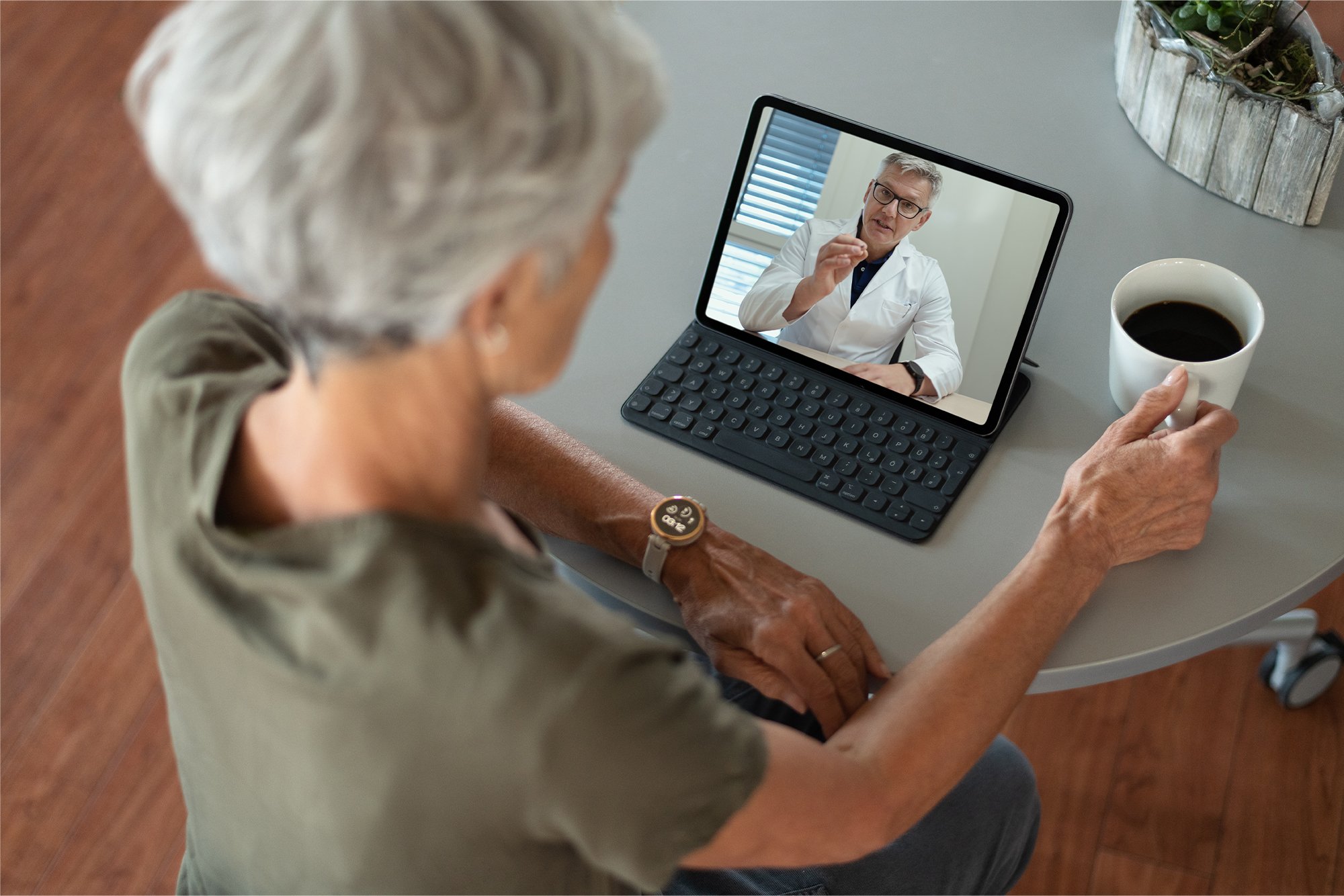 A woman wearing a Garmin smartwatch during a telehealth visit